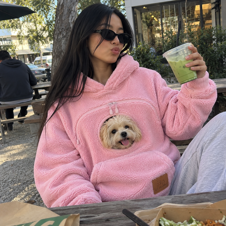 Customer wearing the Doggy Pocket Hoodie with their dog